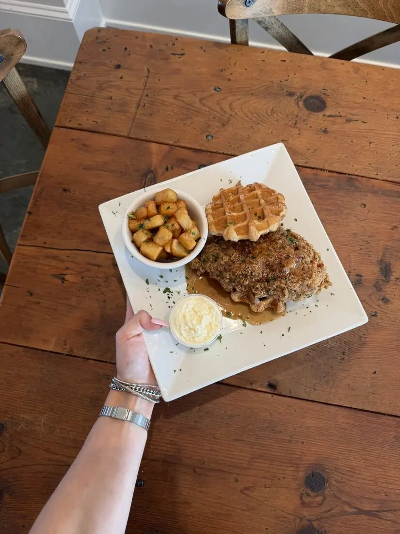 Chicken and waffle sandwich with potatoes