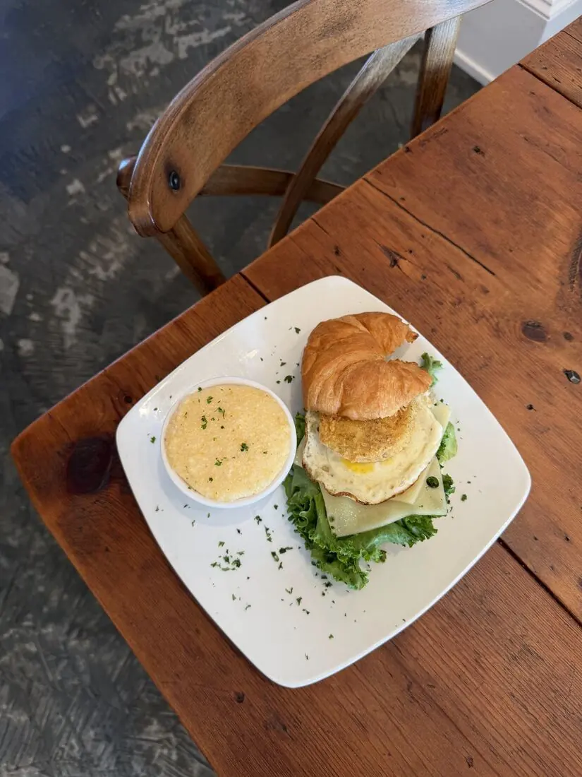 Croissant breakfast sandwich with grits