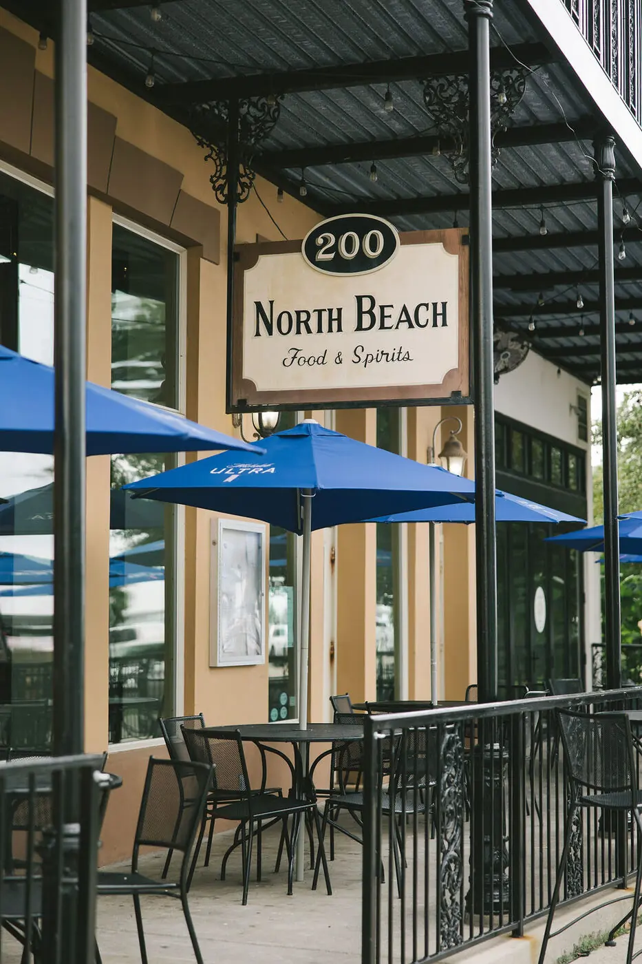 Courtyard seating with blue umbrellas outside the Oyster Bar