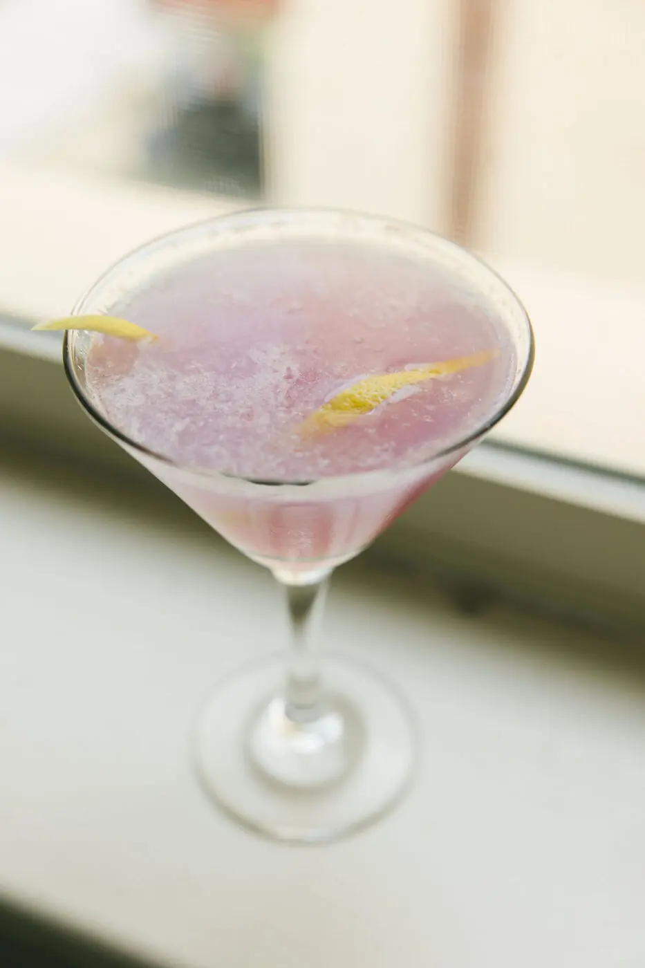 A lavender martini with a lemon twist