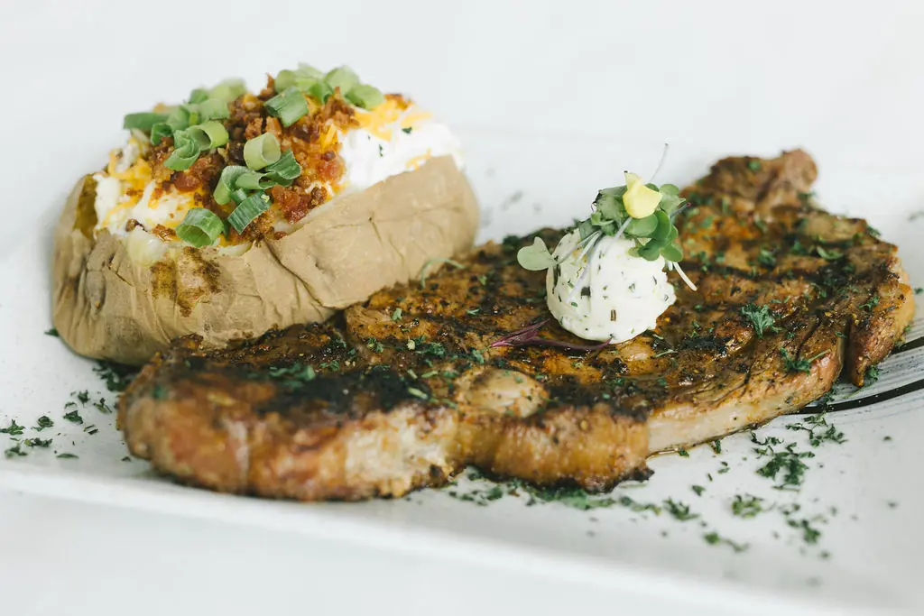 Ribeye with a loaded baked potato